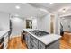 Modern kitchen island with gas range, hardwood floors, and stainless steel appliances at 1209 Colony Cir, Marietta, GA 30068