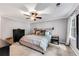 Cozy main bedroom with a ceiling fan, plush carpet, and a comfortable bed, perfect for relaxation at 1209 Colony Cir, Marietta, GA 30068