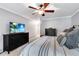 Serene main bedroom with a ceiling fan, plush carpet, and a television for ultimate comfort and entertainment at 1209 Colony Cir, Marietta, GA 30068