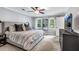 This main bedroom features neutral paint, carpet, a fan, TV, and two windows providing natural light at 1209 Colony Cir, Marietta, GA 30068