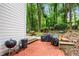 Brick patio with outdoor grilling area offering natural surroundings and mature landscaping at 1209 Colony Cir, Marietta, GA 30068