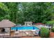 Inviting community pool surrounded by lush greenery, featuring lounge chairs and shaded seating areas at 1209 Colony Cir, Marietta, GA 30068