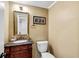 Elegant powder room with a marble countertop vanity and decorative mirror at 1209 Colony Cir, Marietta, GA 30068