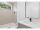 Modern bathroom featuring sleek grey tile, a quartz countertop, and a black faucet at 81 Walthall Se St, Atlanta, GA 30316
