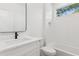 A white bathroom is accented with a black faucet and bright white subway tiling at 81 Walthall Se St, Atlanta, GA 30316
