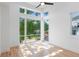 Sunlit room features large windows with neighborhood views and hardwood floors at 81 Walthall Se St, Atlanta, GA 30316