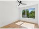 Bright bedroom featuring a modern ceiling fan and a large window with natural light at 81 Walthall Se St, Atlanta, GA 30316
