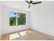 A bright bedroom has hardwood floors and a large window overlooking a green landscape at 81 Walthall Se St, Atlanta, GA 30316