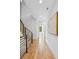 Bright hallway with hardwood floors, modern railing, and decorative art piece at 81 Walthall Se St, Atlanta, GA 30316