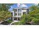 Modern, two-story home with sleek gray and white exterior, complemented by lush landscaping at 81 Walthall Se St, Atlanta, GA 30316