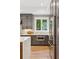 Stylish kitchen with gray cabinetry, stainless steel appliances, and a window overlooking the backyard at 81 Walthall Se St, Atlanta, GA 30316