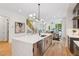 Bright, open kitchen features a waterfall island, modern lighting, and stainless steel appliances at 81 Walthall Se St, Atlanta, GA 30316
