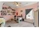 Bedroom with pink walls, carpet floors, ceiling fan and picture gallery on the wall at 110 Ashbury Circle Cir, Dallas, GA 30157