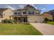 Charming two-story home with a manicured lawn, a two car garage, and a inviting front porch at 110 Ashbury Circle Cir, Dallas, GA 30157