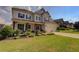 Two-story home features inviting front porch, two-car garage, shutters, and a well-manicured lawn at 110 Ashbury Circle Cir, Dallas, GA 30157