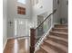 Bright foyer with hardwood floors, staircase, and a decorative 'Hausdorf' sign at 110 Ashbury Circle Cir, Dallas, GA 30157