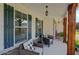 Inviting front porch with two wicker chairs and a lovely hanging lantern pendant at 110 Ashbury Circle Cir, Dallas, GA 30157