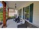 Inviting front porch with two wicker chairs and a lovely hanging lantern pendant at 110 Ashbury Circle Cir, Dallas, GA 30157