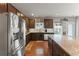 Modern kitchen with stainless steel refrigerator, granite counters, and a view to the backyard at 110 Ashbury Circle Cir, Dallas, GA 30157