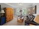 Inviting living room with a leather sofa, wooden furniture, and a decorative Gathering tree art piece at 110 Ashbury Circle Cir, Dallas, GA 30157