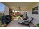 Relaxing covered patio featuring an outdoor fireplace, seating, and a ceiling fan at 110 Ashbury Circle Cir, Dallas, GA 30157