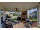Inviting covered patio features an outdoor fireplace, fan, and a relaxing seating arrangement at 110 Ashbury Circle Cir, Dallas, GA 30157