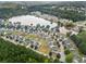 Scenic aerial view of the neighborhood, showcasing homes nestled among lush trees near the lake at 11833 Spring Lake Way, Fayetteville, GA 30215