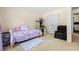 Carpeted bedroom with good natural light and a comfortable sitting area at 11833 Spring Lake Way, Fayetteville, GA 30215