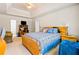 View of main bedroom featuring a tray ceiling, sitting area, and a ceiling fan at 11833 Spring Lake Way, Fayetteville, GA 30215