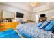 Spacious main bedroom featuring a tray ceiling, sitting area, desk, and television at 11833 Spring Lake Way, Fayetteville, GA 30215