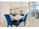 Dining area with marble table, velvet chairs, and adjacent to a kitchen area at 11833 Spring Lake Way, Fayetteville, GA 30215
