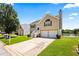 View of two-story home with two-car garage, manicured lawn, and coming soon sign at 11833 Spring Lake Way, Fayetteville, GA 30215