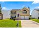 Charming two-story home with a well-maintained lawn and a two-car garage at 11833 Spring Lake Way, Fayetteville, GA 30215
