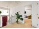 View of hallway with staircase, decorative plant, and doorway to an adjoining room at 11833 Spring Lake Way, Fayetteville, GA 30215