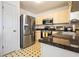 Bright kitchen with stainless steel appliances, granite countertop, and tiled flooring at 11833 Spring Lake Way, Fayetteville, GA 30215