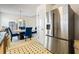 Spacious kitchen with stainless steel appliances, and view into an adjacent dining area, perfect for cooking and entertaining at 11833 Spring Lake Way, Fayetteville, GA 30215