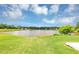 Beautiful view of the lake from the green grass with a blue sky and white clouds at 11833 Spring Lake Way, Fayetteville, GA 30215