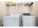 Laundry room with white washer and dryer, and wire shelf above at 11833 Spring Lake Way, Fayetteville, GA 30215