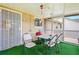 Enclosed patio with table and chairs is perfect for outdoor dining and relaxing at 11833 Spring Lake Way, Fayetteville, GA 30215