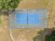 Aerial view of the community tennis court with blue surface and a green surrounding at 11833 Spring Lake Way, Fayetteville, GA 30215