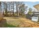 Expansive backyard featuring a lush lawn, mature trees, and a charming fire pit area for outdoor gatherings at 456 Pretty View Se Ln, Smyrna, GA 30082