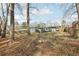 Spacious backyard with a deck, mature trees, and ample room for outdoor activities and entertainment at 456 Pretty View Se Ln, Smyrna, GA 30082