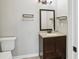 Cozy bathroom featuring a modern vanity, framed mirror, updated lighting, and convenient shelving at 456 Pretty View Se Ln, Smyrna, GA 30082