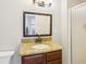 Bathroom featuring a sink, granite countertops, and a framed mirror at 456 Pretty View Se Ln, Smyrna, GA 30082