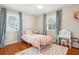 Bright bedroom with hardwood floors, natural light, and pink color accents at 456 Pretty View Se Ln, Smyrna, GA 30082