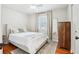 Cozy bedroom featuring hardwood floors, large bed, ceiling fan, and natural light at 456 Pretty View Se Ln, Smyrna, GA 30082