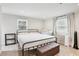 Bright bedroom featuring a metal bed frame, neutral color palette, and plush carpet at 456 Pretty View Se Ln, Smyrna, GA 30082