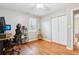 Comfortable office space with wood floors, filled with natural light, and a guitar at 456 Pretty View Se Ln, Smyrna, GA 30082