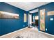Basement features a built-in desk, decor and blue walls at 6490 Ivey Hill Dr, Cumming, GA 30040
