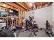 Basement features gym area with mounted television and workout equipment at 6490 Ivey Hill Dr, Cumming, GA 30040